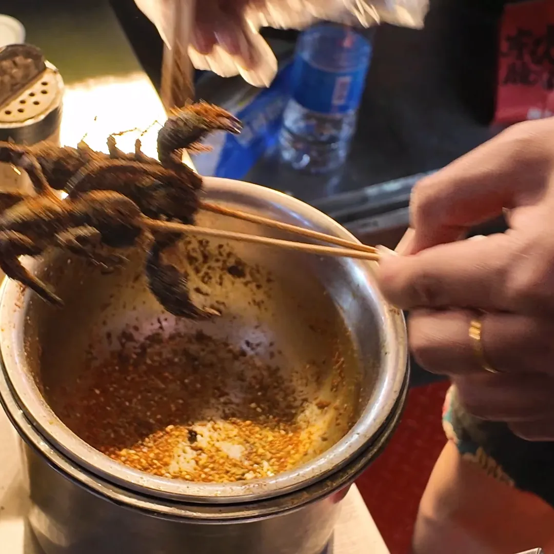Spice-coated fried scorpion skewers ready to eat