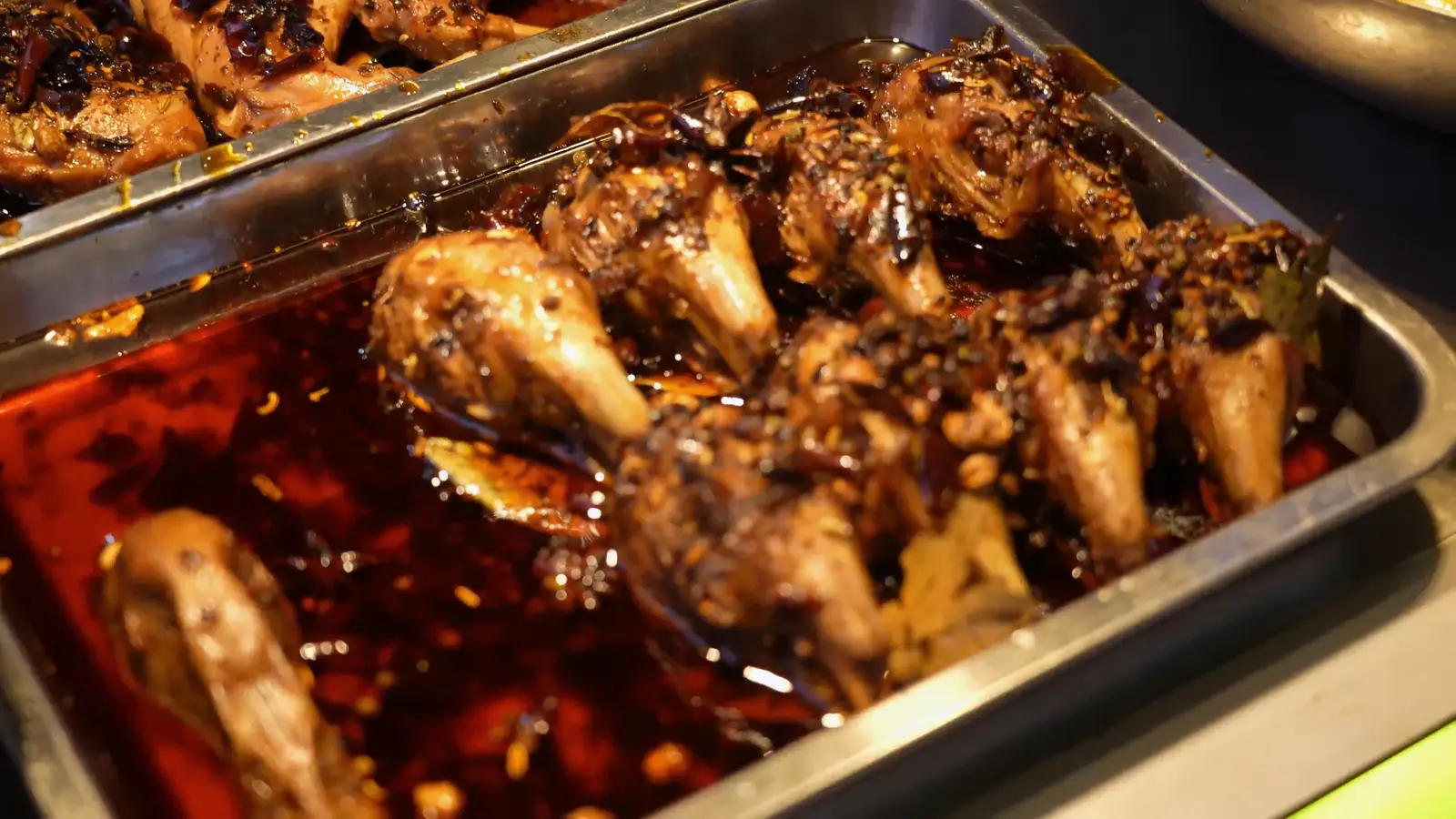 A plate of oil-braised spicy rabbit heads in Chengdu